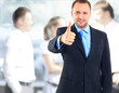 Businessman showing OK sign with his thumb up