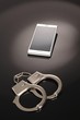 Foto: Handy und Handschellen Handy und Handschellen