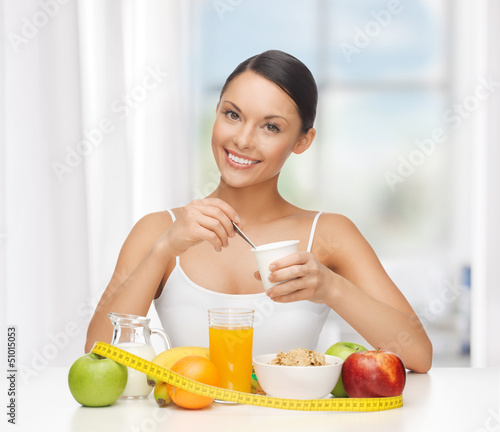 Photo: woman with healthy breakfast and measuring tape woman with healthy breakfast and measuring tape