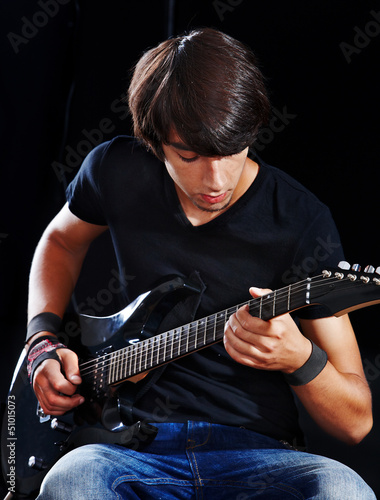 Photo: Man playing guitar. Man playing guitar.
