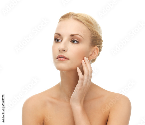 Photo: woman touching her face skin woman touching her face skin