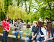 Photo: Group of people in city park listen music. Group of people in city park listen music.
