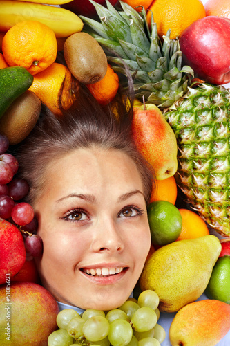 Photo: Girl in group of fruit. Girl in group of fruit.