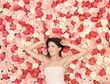 young woman with background full of roses