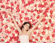 young woman with background full of roses
