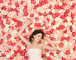 young woman with background full of roses