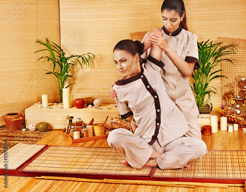 Photo: Therapist giving stretching massage to woman. Therapist giving stretching massage to woman.