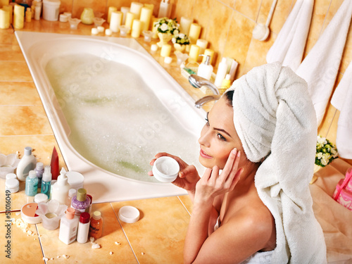Photo: Woman applying moisturizer. Woman applying moisturizer.