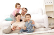 Family lying on a carpet in their living room