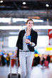 Foto: Pretty young female passenger at the airport (shallow DOF; color Pretty young female passenger at the airport (shallow DOF; color