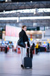 Foto: Pretty young female passenger at the airport (shallow DOF; color Pretty young female passenger at the airport (shallow DOF; color