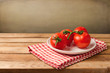 Fresh tomatoes on plate on wooden table