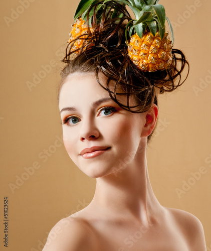 Photo: Beautiful woman with a pineapple in her hair Beautiful woman with a pineapple in her hair