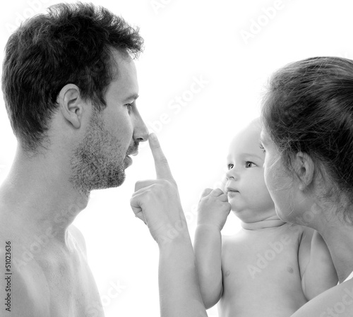 Photo: Happy young family with baby. Indoors. Happy young family with baby. Indoors.