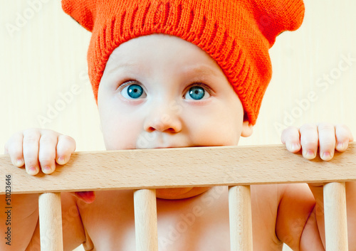 Photo: baby in a crib in the cap baby in a crib in the cap