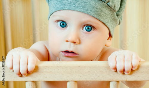 Photo: baby in a crib in the cap baby in a crib in the cap