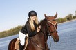 Happy rider caressing horse