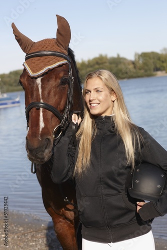 Photo: Portrait of young female rider and horse Portrait of young female rider and horse
