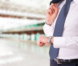 Businessman checking time on his wristwatch.