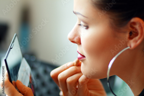 Photo: woman applying make-up woman applying make-up