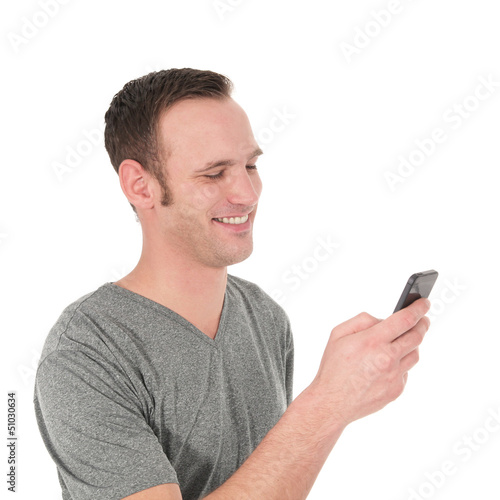 Photo: Happy young man reading a text message Happy young man reading a text message