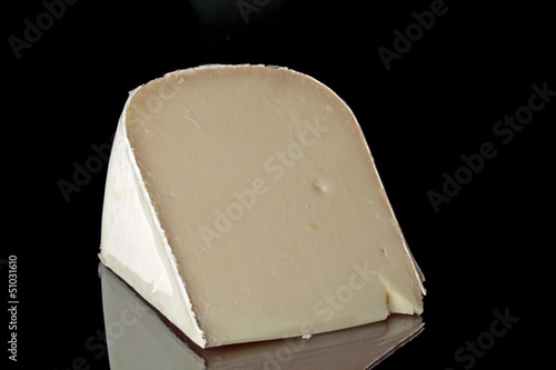 Photo: Dutch goat cheese on a black background Dutch goat cheese on a black background