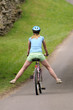 Female cyclist riding with her legs outstretched