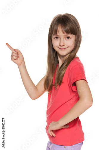 Photo: Young girl shows her finger to the side Young girl shows her finger to the side