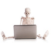 Skeleton working on laptop
