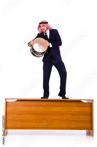 Photo: Arab businessman playing drum on desk Arab businessman playing drum on desk