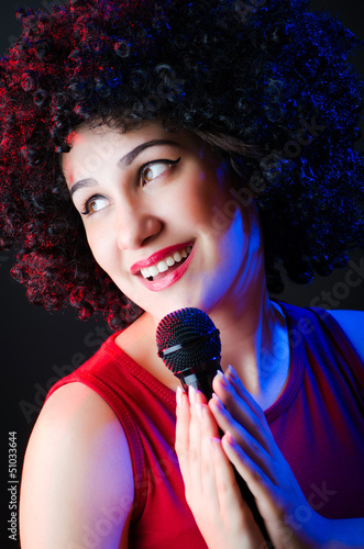 Photo: Female performer at disco with mic Female performer at disco with mic