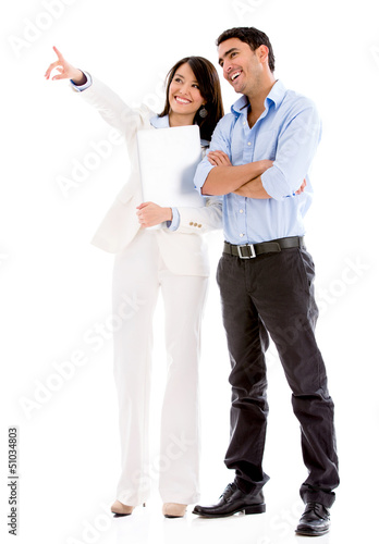 Photo: Business couple pointing away Business couple pointing away