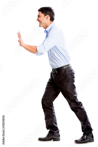 Photo: Business man pushing object Business man pushing object