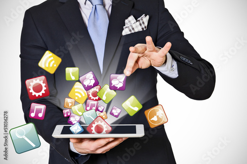 Photo: business man which extracts digital icons business man which extracts digital icons