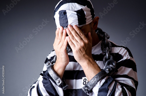 Photo: Convict criminal in striped uniform Convict criminal in striped uniform