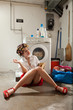 A housewife reading a book and dreaming in the laundry room