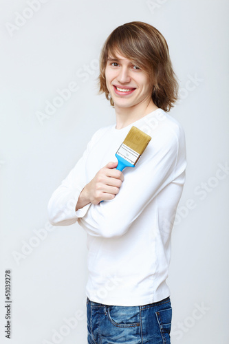 Photo: Man with paint brushes Man with paint brushes
