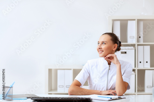 Photo: Young female doctor in white uniform Young female doctor in white uniform