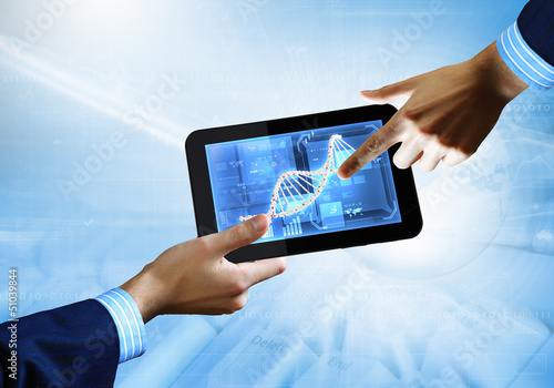 Photo: Dna strand On The Tablet Screen Dna strand On The Tablet Screen