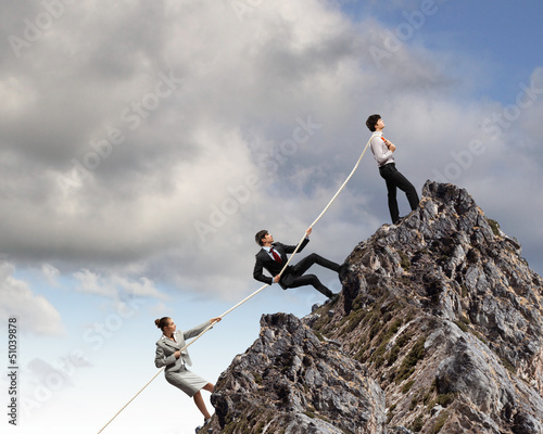 Photo: Three business people pulling rope Three business people pulling rope