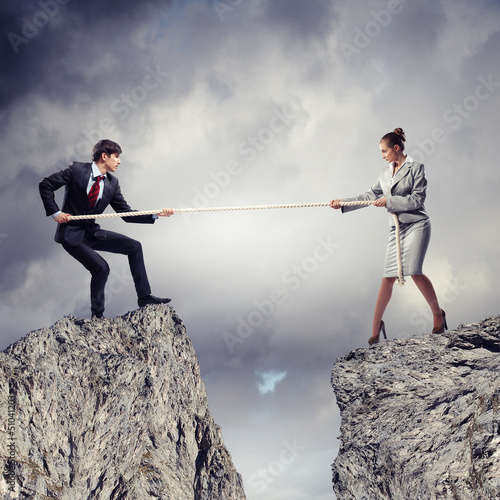 Photo: People pull the rope. People pull the rope.