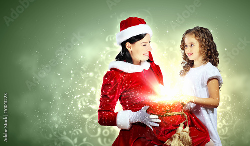 Photo: Little girl with christmas gifts and santa Little girl with christmas gifts and santa