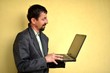 Photo: Business man holding a laptop Business man holding a laptop