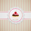 Cupcake with pink creme on lace and striped table cloth