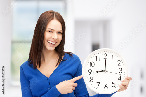 Photo: woman holding big clock woman holding big clock