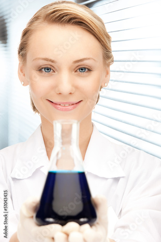 Photo: lab worker holding up test tube lab worker holding up test tube