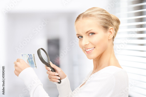Photo: woman with magnifying glass and money woman with magnifying glass and money