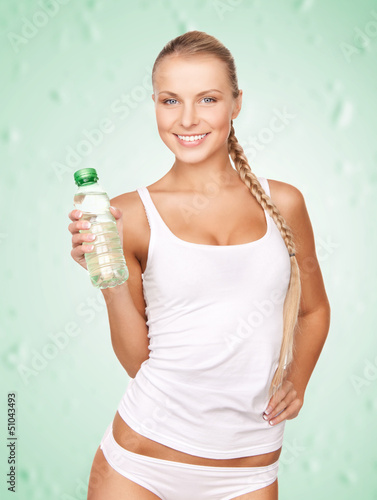 Photo: young beautiful woman with bottle of water young beautiful woman with bottle of water