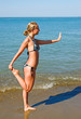 Slender girl doing yoga on the beach