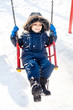 Kid swinging in the snow